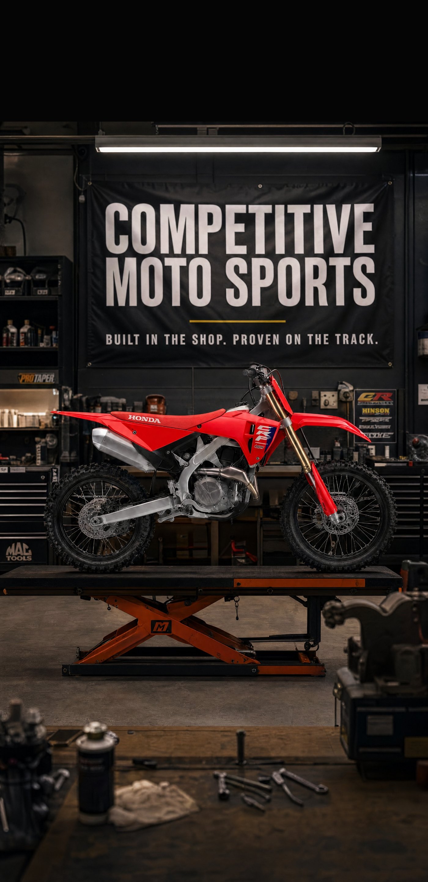 Honda CRF450R dirt bike on the service lift at Competitive Moto Sports in Conneaut, Ohio